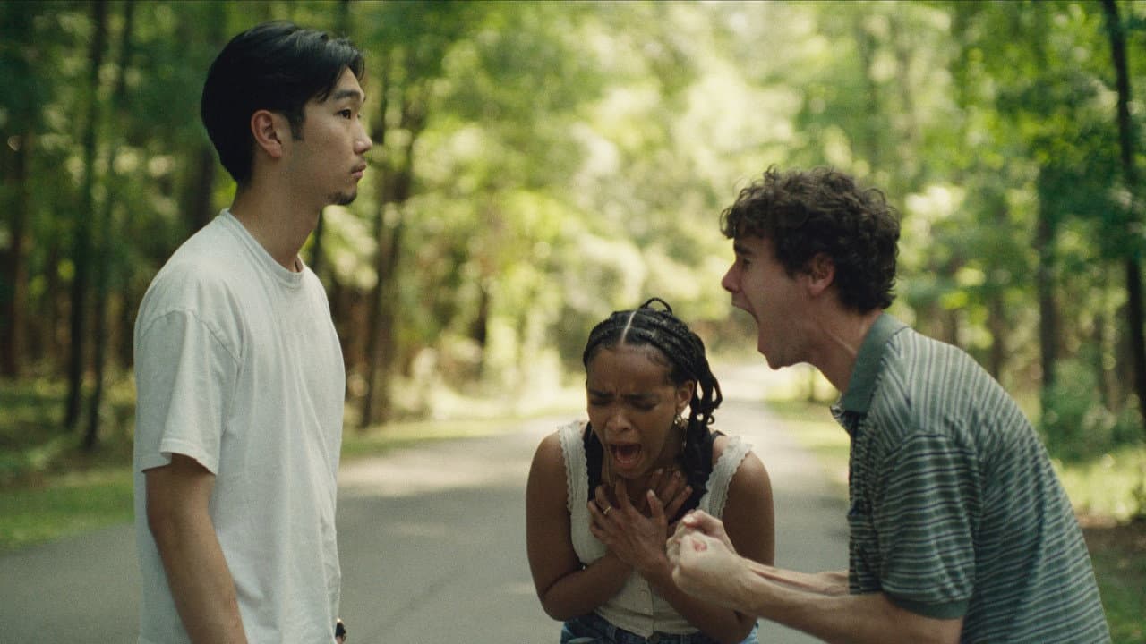 A still from It Ends, showing three of the film's leads on a tree-lined road
